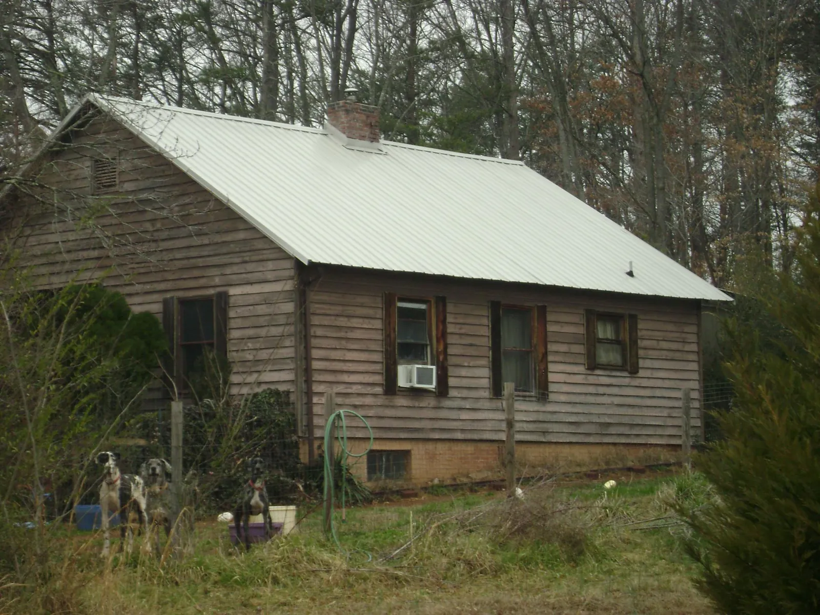 White metal roof on an old wood sided farmhouse, from a Metal Roof Installation job in Reedsville